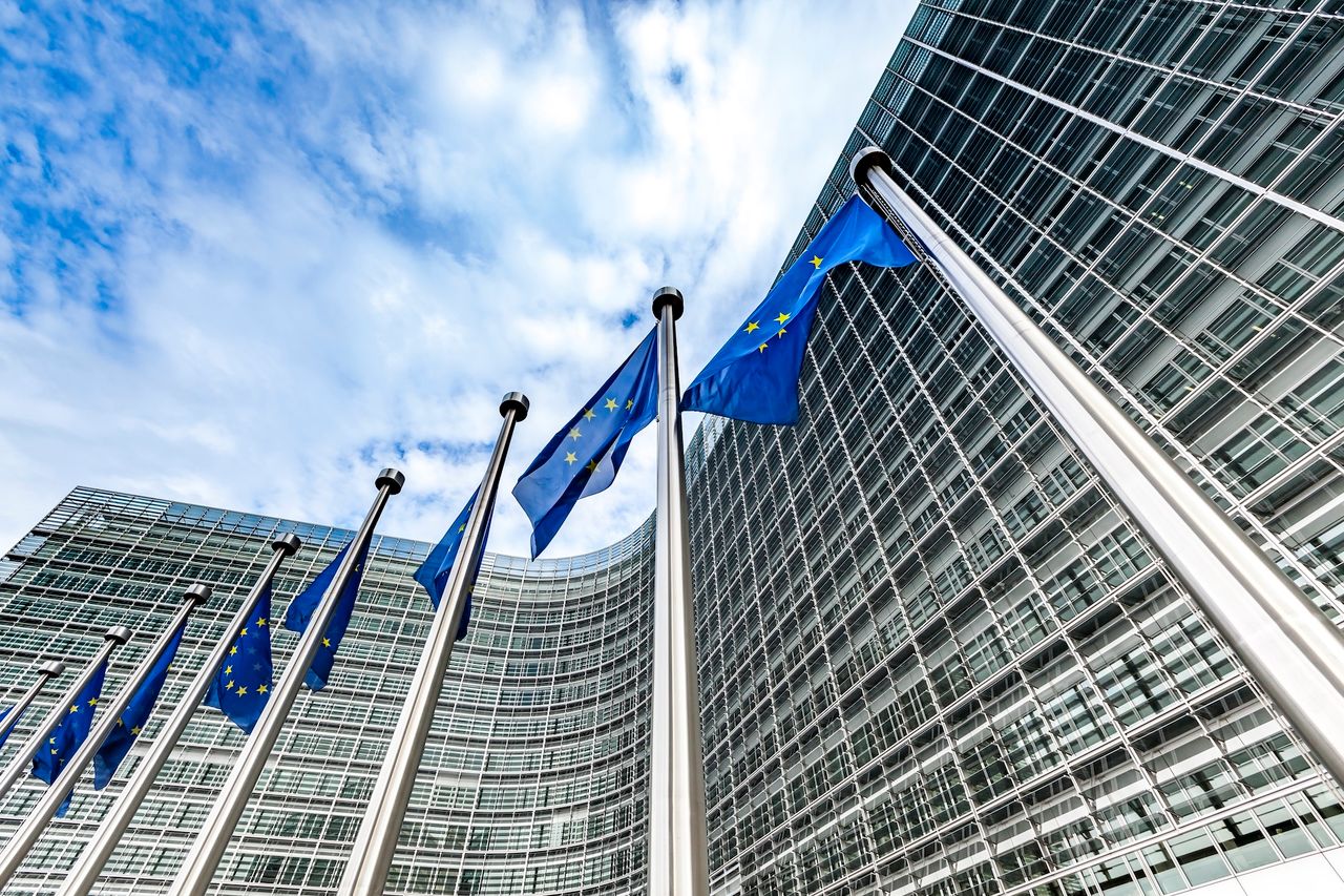 <p>european union blue and gold flags flying in the wind in brussels city in belgium.</p>