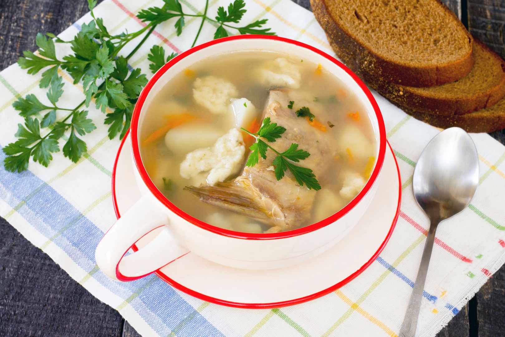 Soup with fresh fish and dumplings in a rustic style 