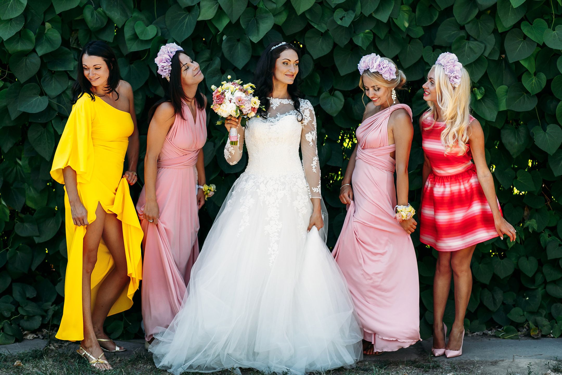 Bride with bridesmaids at  wedding walk outdoors 