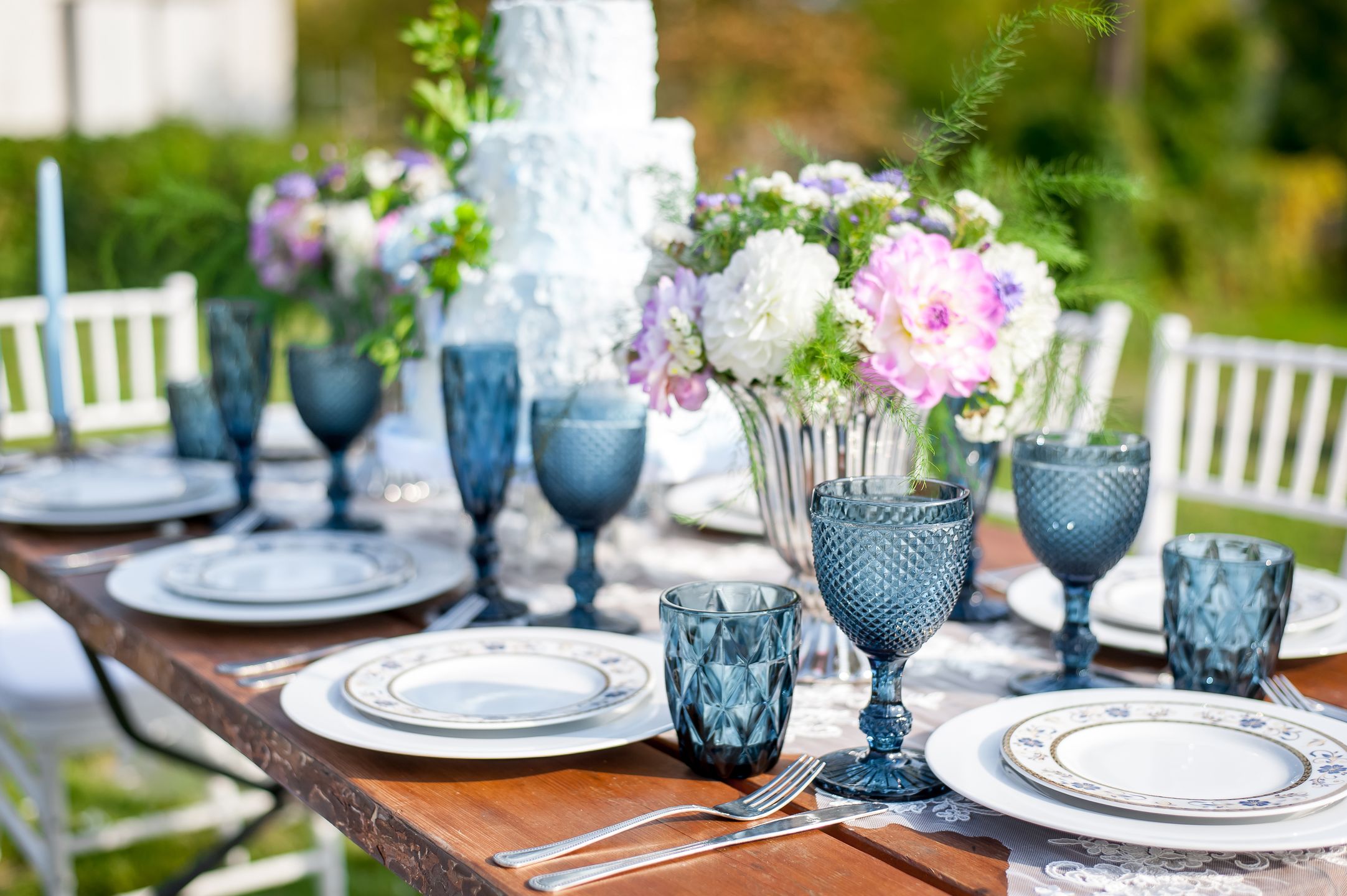 Decorated wedding table with candles in the garden 