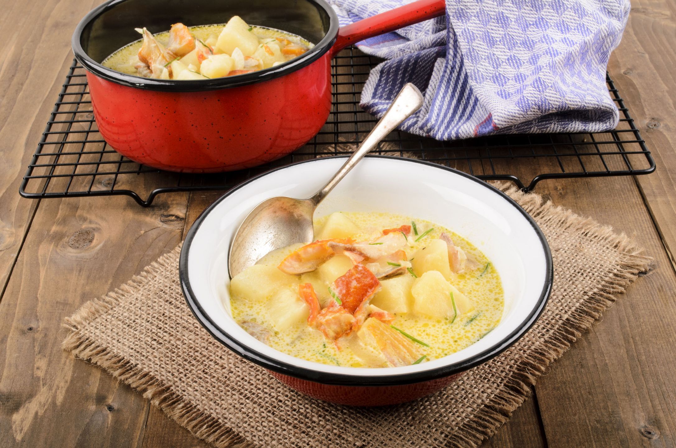 cullen skink, typical scottish food with smoked haddock in a pot and bowl on jute 