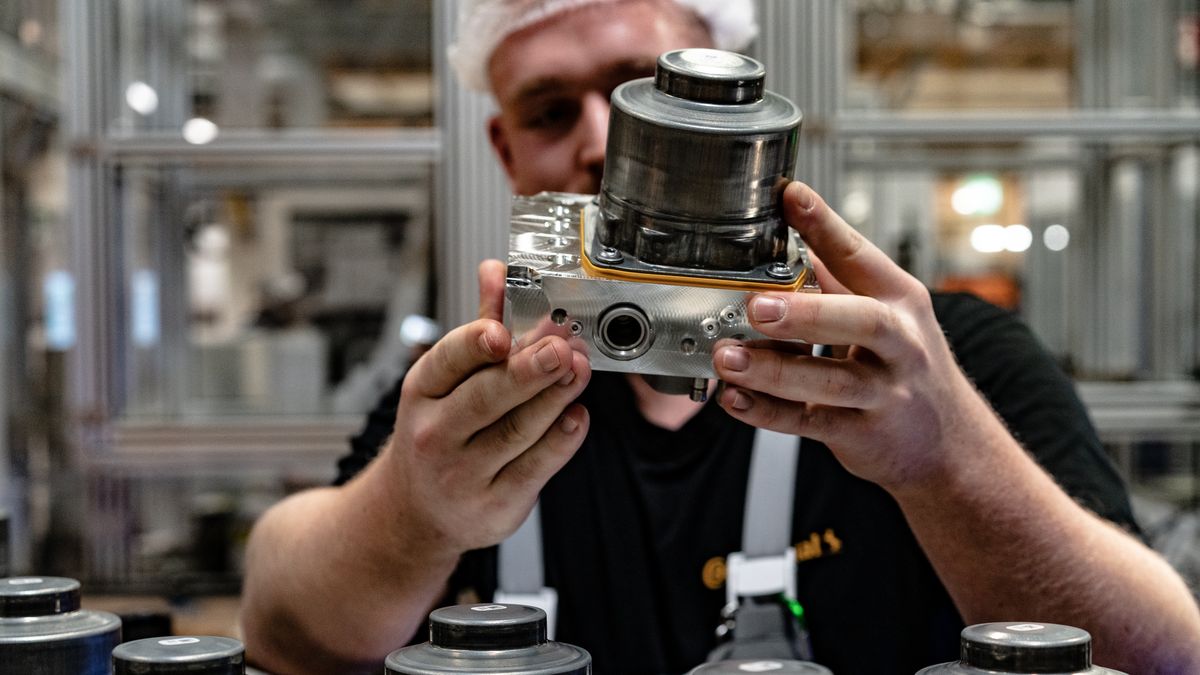 An employee checks a cylinder component for the MK C2 brake system module at on the production line at the the Continental AG manufacturing plant in Frankfurt, Germany, on Friday, March 3, 2022. The German auto supplier is scheduled to announce full year earnings on March 8. Photographer: Ben Kilb/Bloomberg via Getty Images