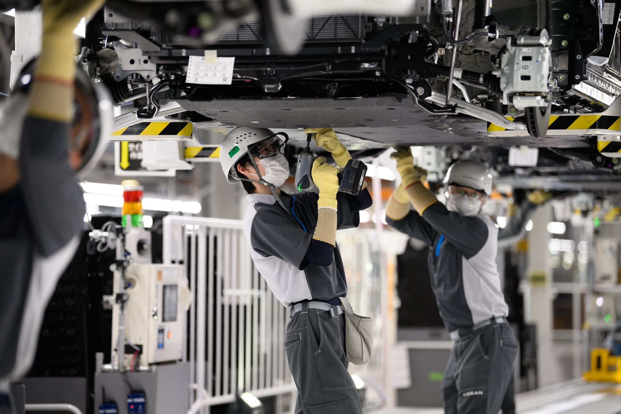 Workers assemble Nissan Motor Co.'s Ariya electric crossover sport utility vehicles (SUV) on the production line of the Nissan Intelligent Factory at the company's plant in Kaminokawa, Tochigi Prefecture, Japan, on Friday, Dec. 8, 2023. The Nissan Tochigi plant and its technologies are designed to serve as a model for global plants. Photographer: Akio Kon/Bloomberg via Getty Images