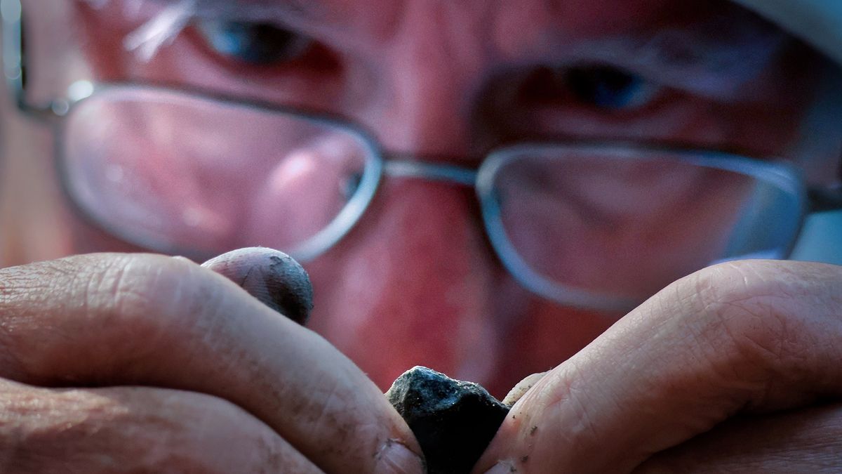Boston, MA - May 27: Volunteer Tim Riordan inspects an excavated artifact in a backyard off of Monument Avenue on May 27, 2025. (Photo by Lane Turner/The Boston Globe via Getty Images)