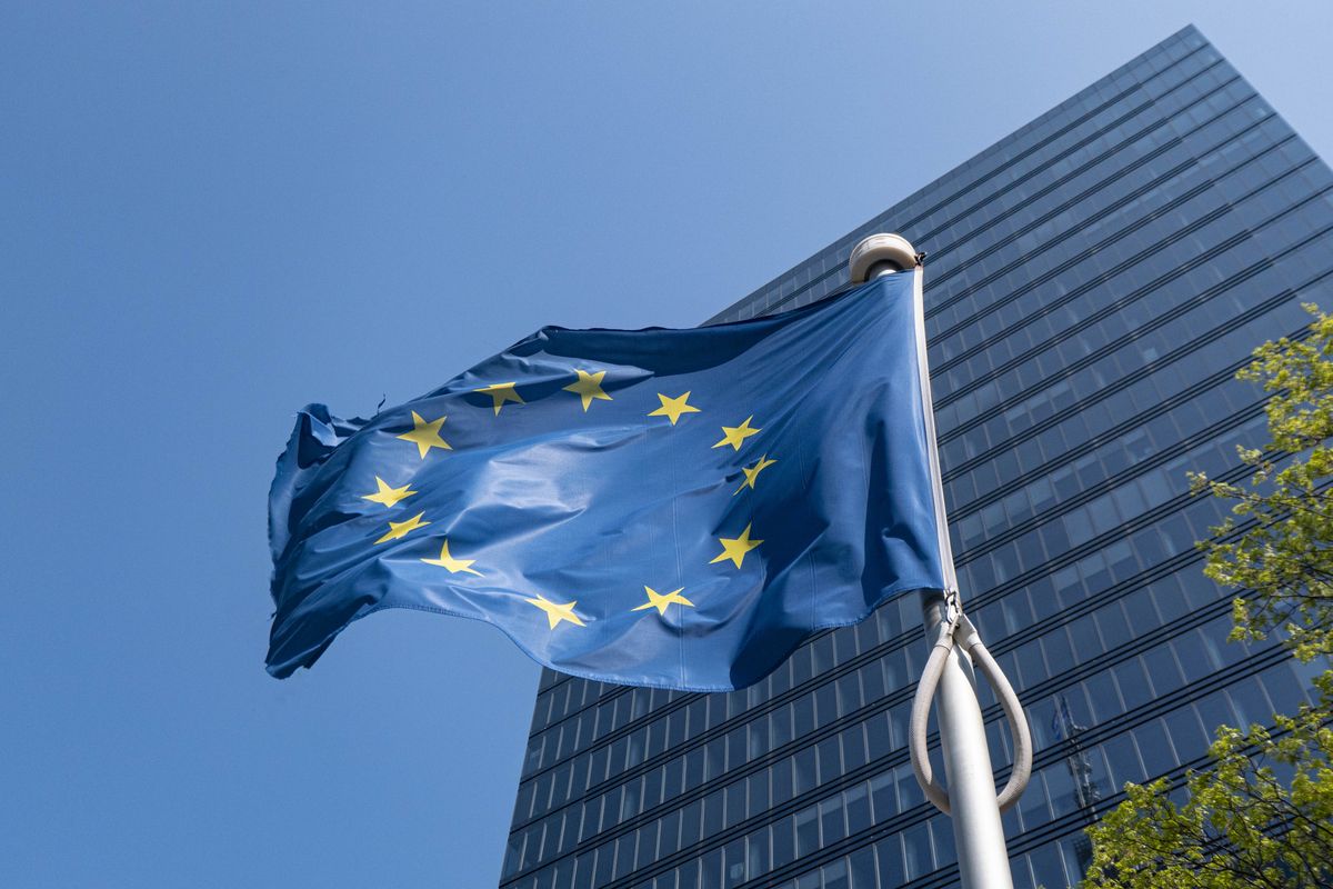 Flag of Europe on flagpole waving in the blue sky on a sunny day among the high buildings in the European capital city Brussels near Brussels North Railway station. The flag of Europe or the European Flag is the symbol of the Council of Europe CoE and The European Union EU as seen in the Belgian capital Brussel. Brussels, Belgium on April 24, 2022 (Photo by Nicolas Economou/NurPhoto via Getty Images)