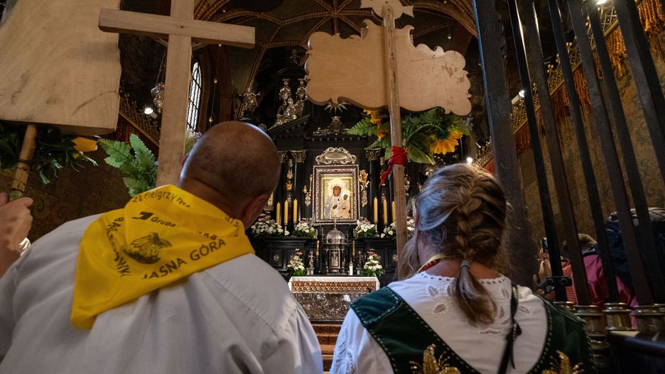CZESTOCHOWA, POLAND - 2021/07/31: A couple of highlanders praying before the image of Black Madonna in the chapel, during the pilgrimage.Every year in summer, thousands of pilgrims come to Jasna Gora Monastery in Czestochowa to pray before the image of Black Madonna. The Monastery in Jasna Gora is the biggest sanctuary in Poland for all Catholics. (Photo by Wojciech Grabowski/SOPA Images/LightRocket via Getty Images)