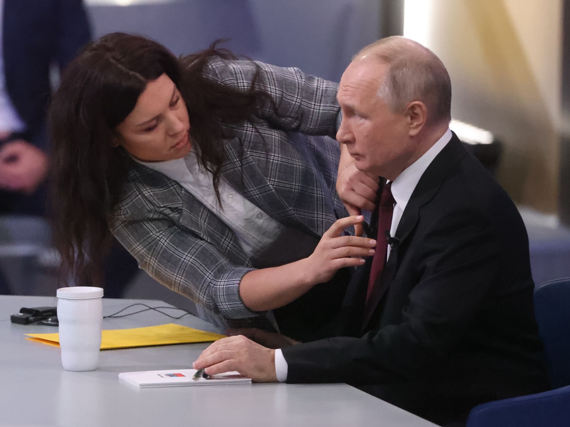 Russian President Putin's Combines Call-In-Show Annual Press ConferenceMOSCOW, RUSSIA - DECEMBER 14: (RUSSIA OUT) An assistant helps Russian President Vladimir Putin (R) during his combine call-in-show and annual press conference on December 14, 2023 in Moscow, Russia. About 1000 journalists were gathered in the Moscow Gostiny Dvor, also known as the Old Merchant Court for Putin's 4-hours long annual event, as a part of his campaign for the 2024 Presidential elections. (Photo by Contributor/Getty Images)Contributor