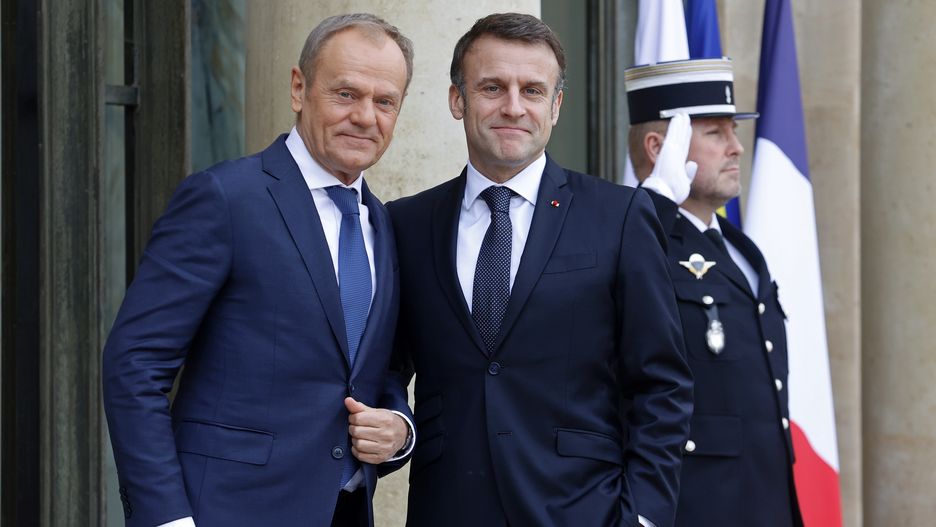 PARIS, FRANCE - FEBRUARY 12: French President Emmanuel Macron (R) welcomes Poland's Prime Minister Donald Tusk prior to a working lunch at Elysee Presidential Palace on February 12, 2024 in Paris, France. The Polish Prime Minister Donald Tusk assumed office in December after his alliance displaced the conservative Law and Justice Party in Poland's general elections. (Photo by Chesnot/Getty Images)