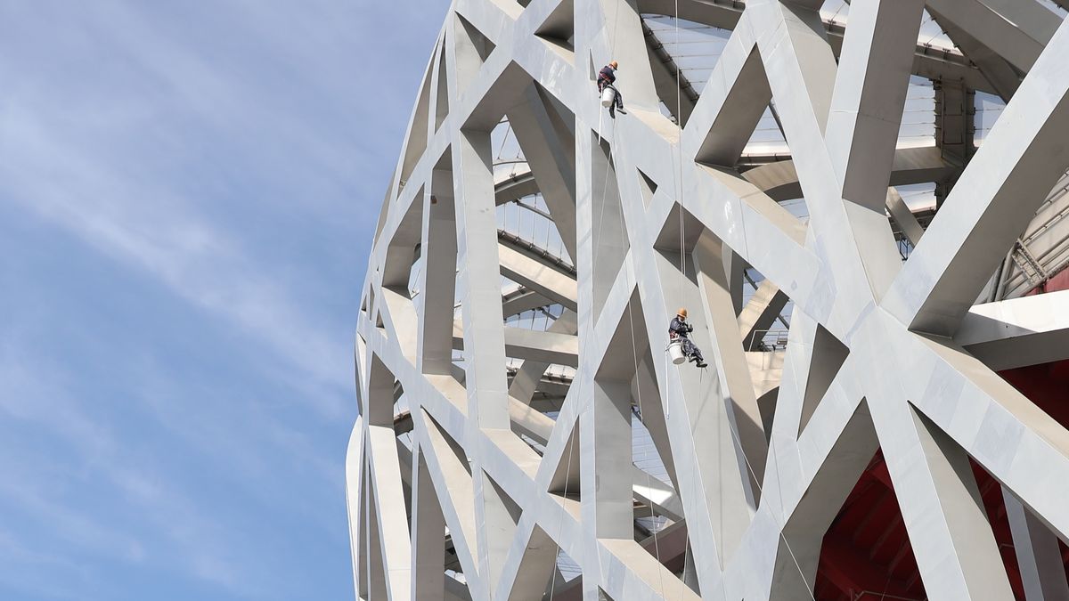 BEIJING, CHINA - FEBRUARY 24: Workers clean the Bird's Nest Stadium on February 24, 2025 in Beijing, China. (Photo by Charle He/Getty Images)