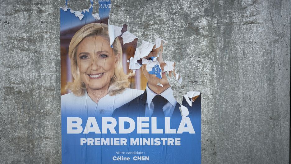 PARIS, FRANCE - JUNE 23: An electoral poster featuring Marine le Pen and the defaced photo of Jordan Bardella, of the far right party the Rassemblement National, or National Rally, in the 10th arrondissement on June 23, 2024 in Paris, France. Posters with images of the candidates for the legislative elections are being put up in front of various voting stations, such as public schools and other municipality buildings. The first round of voting will take place on June 30th 2024, followed a week later by the second round of voting on July 7th 2024. These elections are the result of the decision of the French president, Emmanuel Macron, to dissolve parliament after gains by the far-right party Rassemblement National, or National Rally during the recent European elections. (Photo by Remon Haazen/Getty Images)
