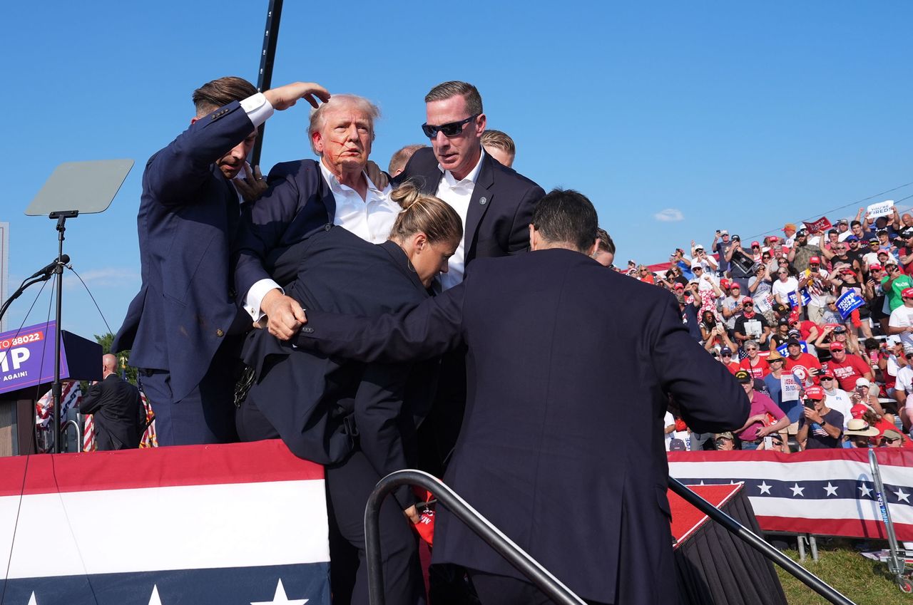 Donald Trump evacuated from the stage after being grazed by a bullet from an attacker