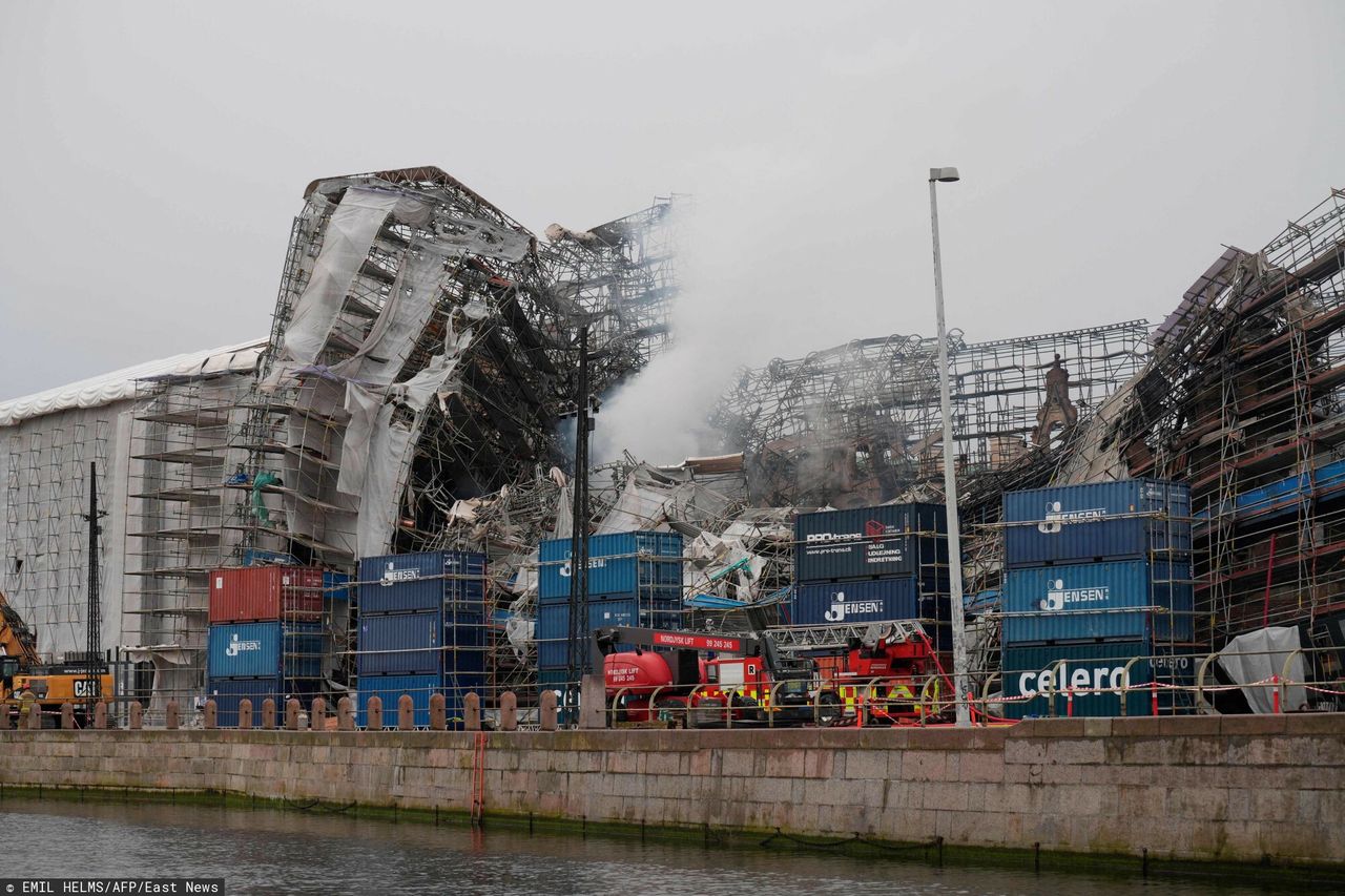 One of the outer walls of the building of the Old Stock Exchange in Copenhagen, damaged by fire, collapsed during a live broadcast on Danish television.