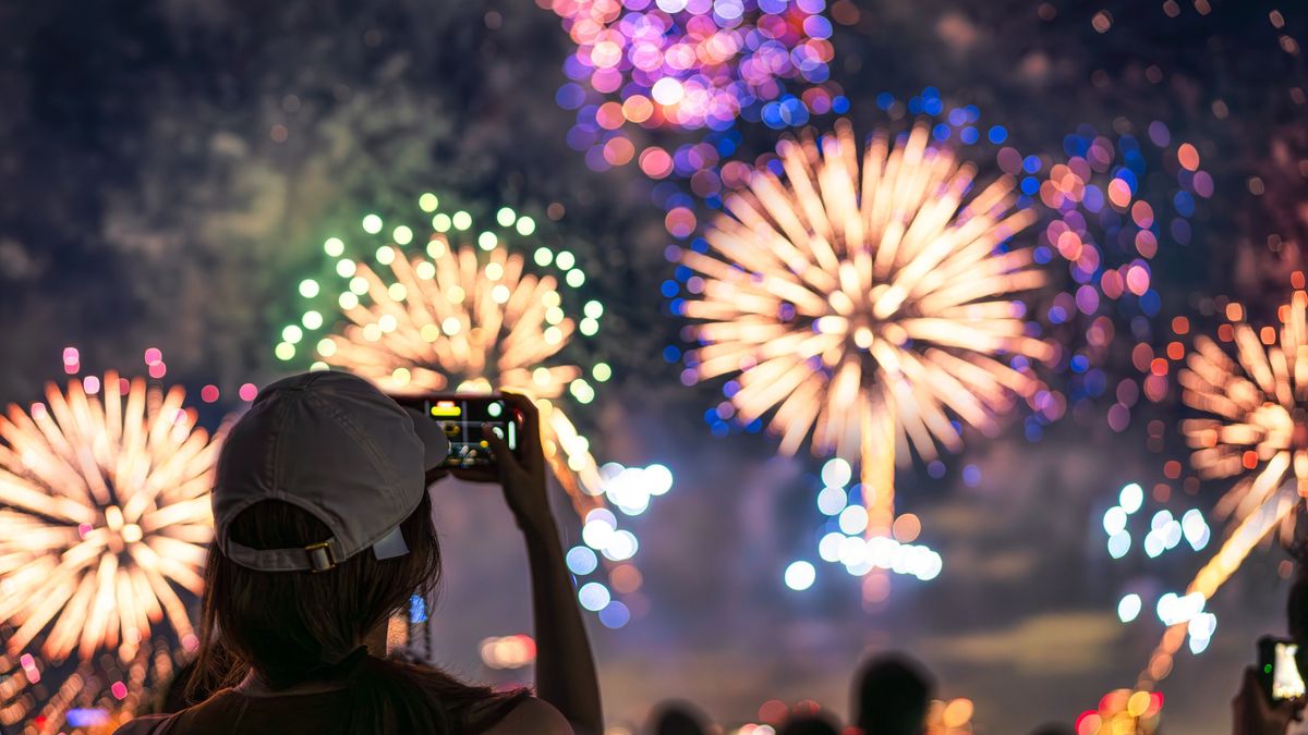 girl watching a firework display.
The back of a girl in a baseball cap filming a fireworks display on her mobile phone
JaCZhou
multi coloured, colour image