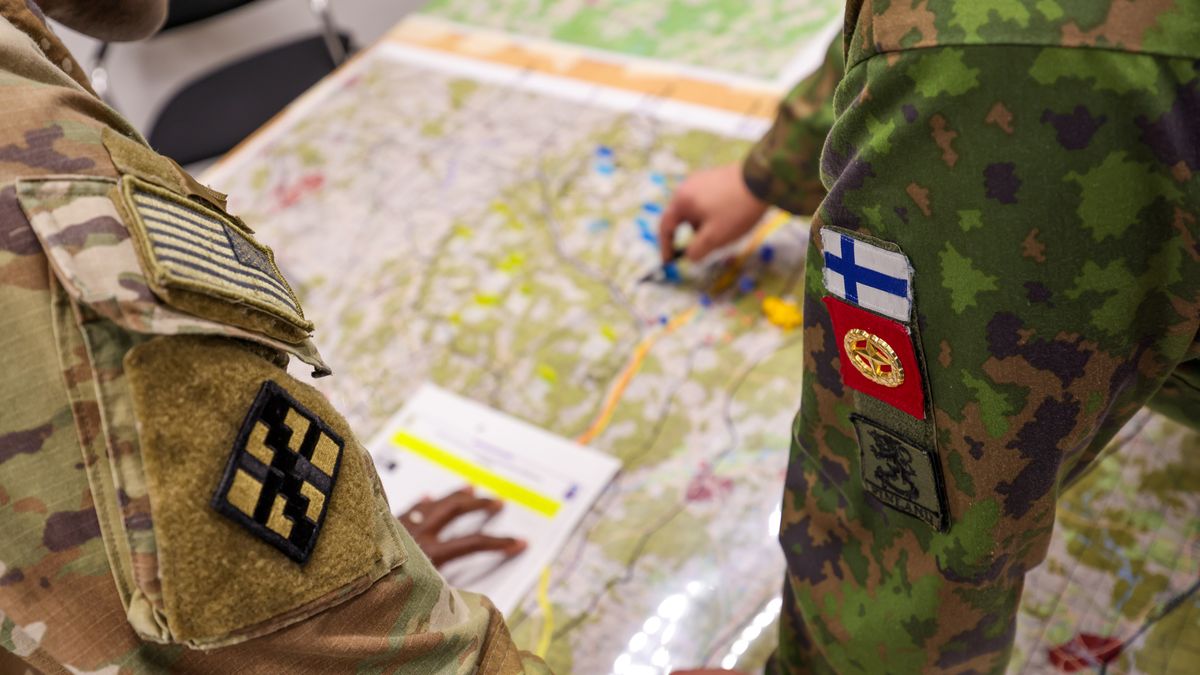 Representatives from the US Army, left, and the Finnish Army, right, inspect a map during a staged fight and evacuation of injured soldiers at a Combined Resolve multinational training exercise, with participating forces from the US, Finland and Romania, at the Hohenfels Training Area in Hohenfels, Germany, on Monday, Oct. 30, 2023. Combined Resolve is a multinational exercise conducted at the Joint Multinational Readiness Center, designed to test and certify brigade combat teams, as well as build interoperability with US allies and partners. Photographer: Alex Kraus/Bloomberg via Getty Images