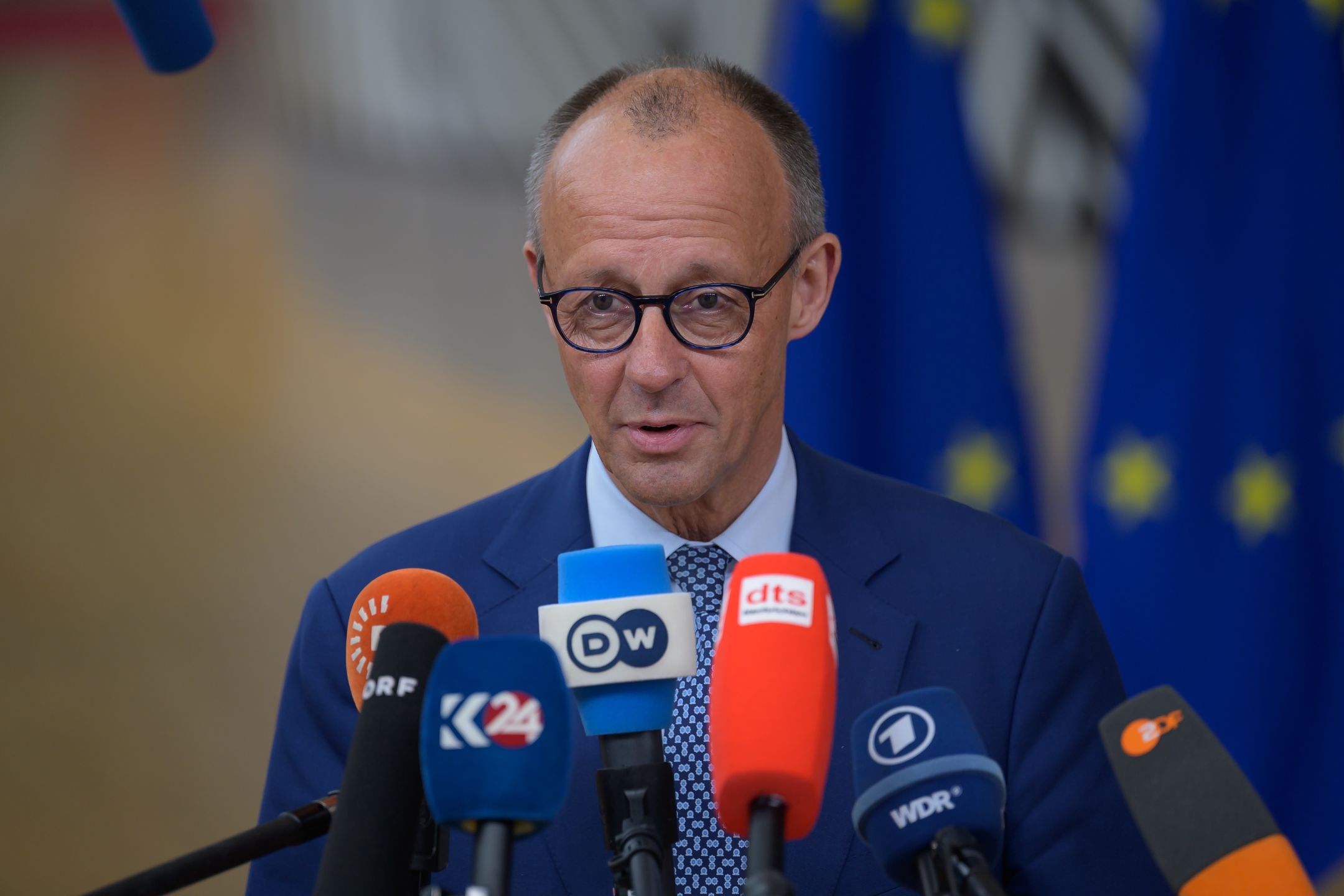 German Chancellor Friedrich Merz talks to the press as he arrives for the summit. EU leaders meet in Brussels, Belgium, on June 26, 2025, to discuss geoeconomic challenges and the ongoing developments in Ukraine and the Middle East. (Photo by Jonathan Raa/NurPhoto via Getty Images)