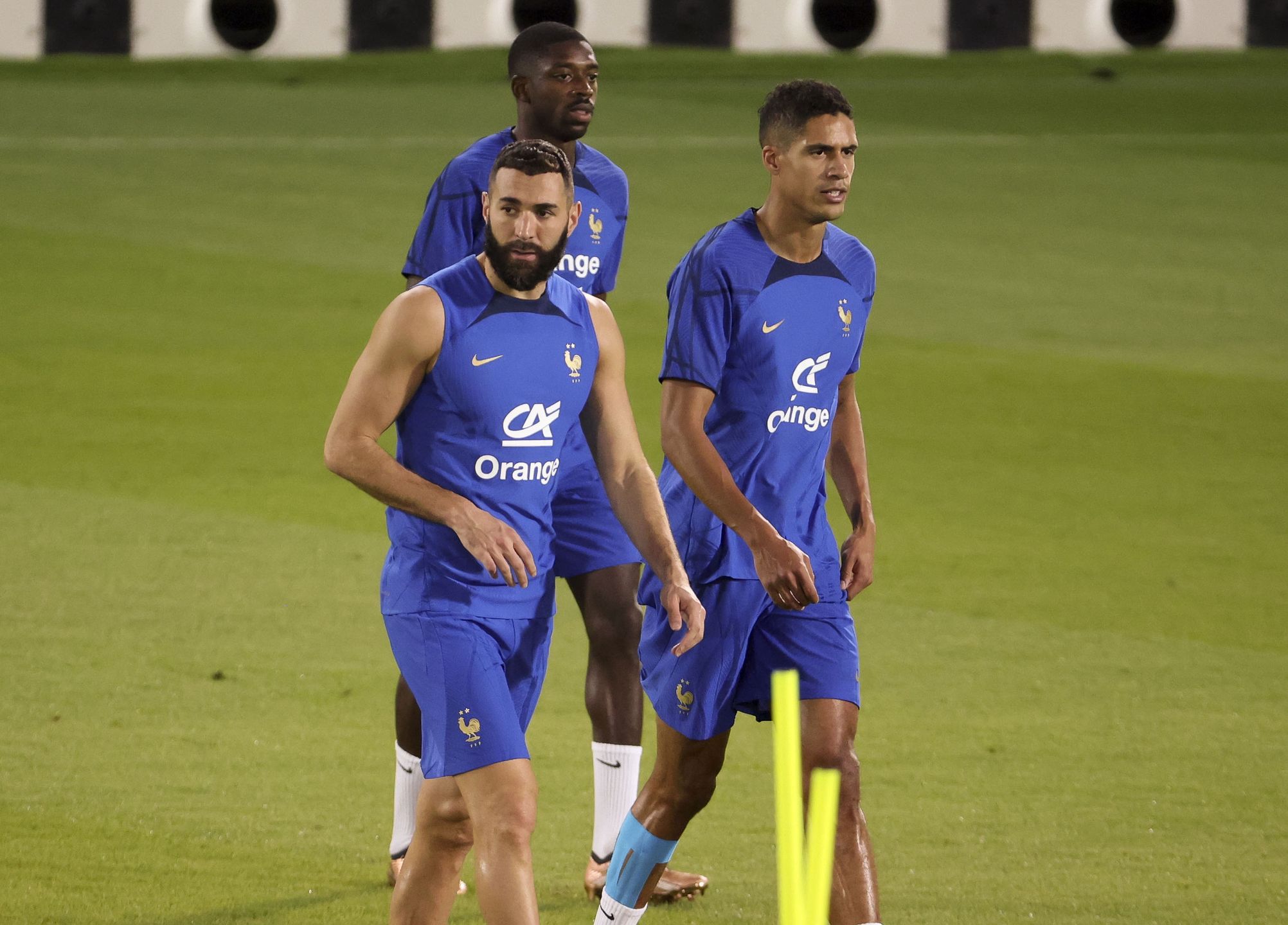 DOHA, QATAR - NOVEMBER 19: Karim Benzema, Raphael Varane, behind Ousmane Dembele of France during Team France practice ahead of the FIFA World Cup Qatar 2022 at Al Sadd SC Stadium on November 19, 2022 in Doha, Qatar. (Photo by Jean Catuffe/Getty Images)