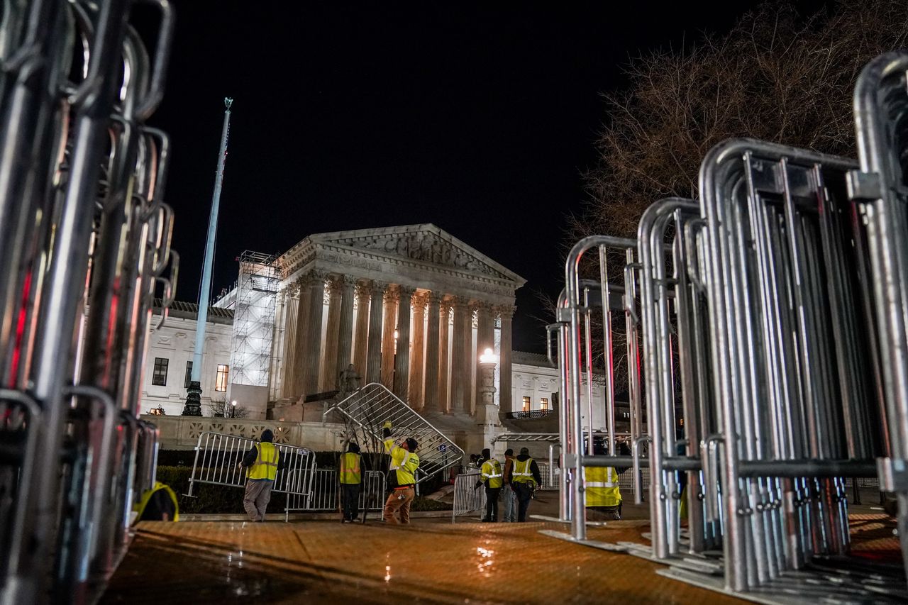 WASHINGTON, DC FEBRUARY 7: 
Workers put security fencing around the outside of the United States Supreme Court on February 7, 2024, in Washington, DC.  The Supreme Court this week will confront the critical question of Donald Trump's eligibility to return to the White House, hearing argument in an unprecedented case that gives the justices a central role in charting the course of a presidential election for the first time in nearly a quarter-century. The justices will decide whether Colorado's top court was correct to apply a post-Civil War provision of the Constitution to order Trump off the ballot after concluding his actions around the Jan. 6, 2021, attack on the Capitol amounted to insurrection. 
(Photo by Jahi Chikwendiu/The Washington Post via Getty Images)
