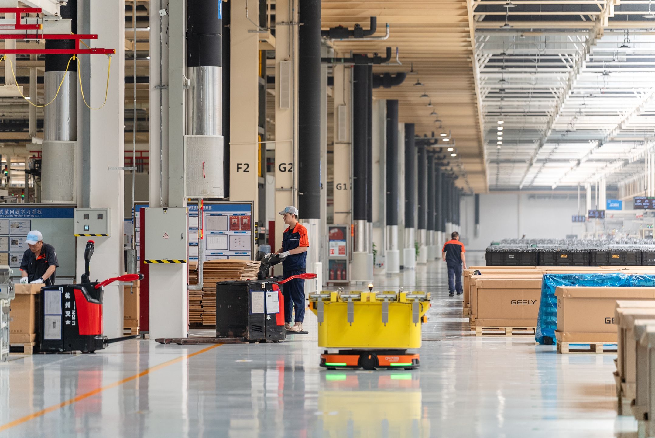 YIWU, CHINA - JUNE 17: An intelligent robot transports components of M252 engine at the workshop of Zhejiang Yili Automobile Components Co., Ltd. on June 17, 2025 in Yiwu, Zhejiang Province of China. The M252 engine, which was jointly developed by Geely Automobile and Mercedes-Benz, will be exported to Germany. (Photo by VCG/VCG via Getty Images)