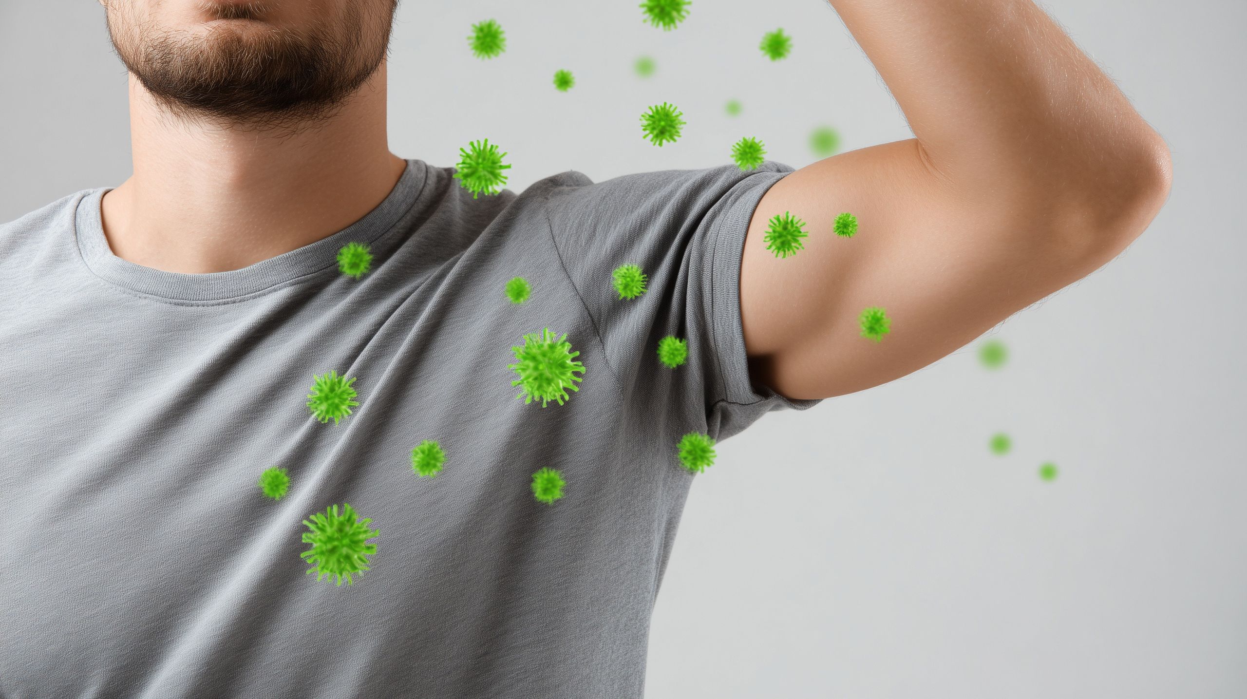  Zbliżenie na okolice pachy mężczyzny z ilustracjami bakterii