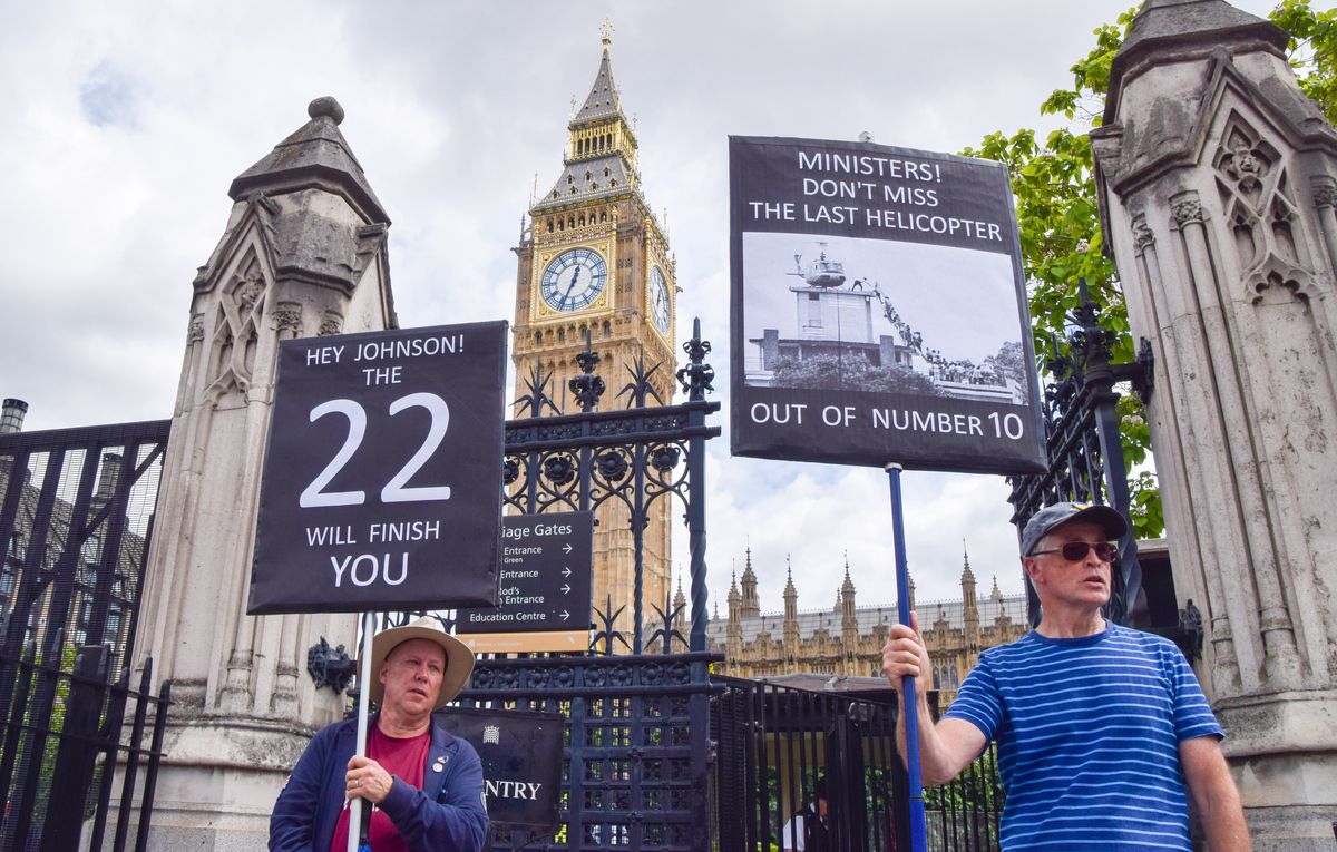 LONDON, UNITED KINGDOM - 2022/07/06: Protesters hold placards mocking the Tory (Conservative) Party and Boris Johnson during the demonstration outside Parliament. Anti-Boris Johnson protesters gathered in Westminster as numerous ministers resigned from the Tory Government and pressure piles on Johnson to resign. (Photo by Vuk Valcic/SOPA Images/LightRocket via Getty Images)