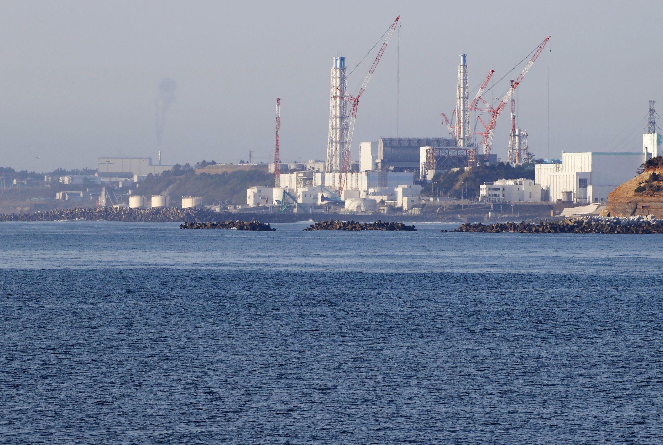 Photo taken April 12, 2021, from the Fukushima Prefecture town of Namie, northeastern Japan, shows the Fukushima Daiichi nuclear power plant crippled in the March 2011 earthquake and tsunami. (Photo by Kyodo News via Getty Images)