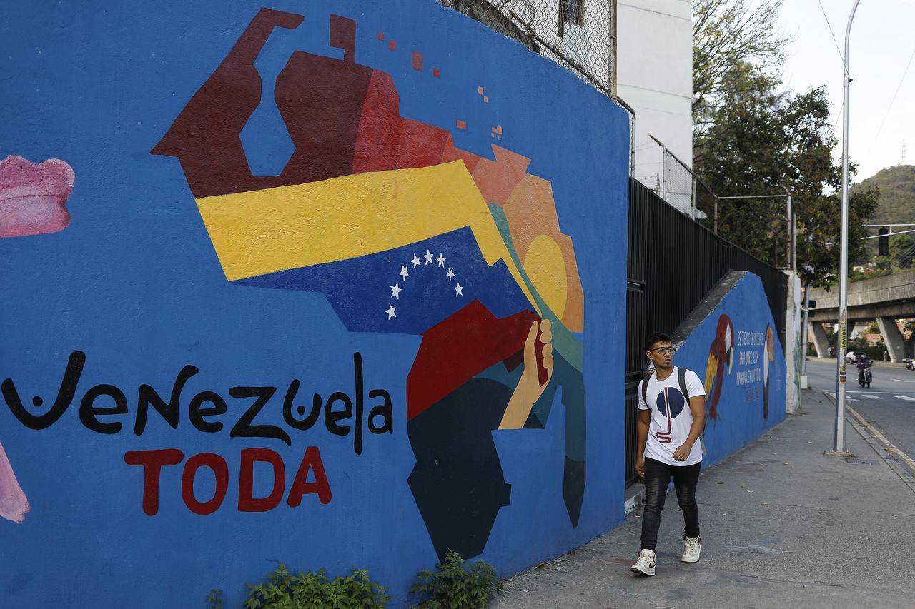 CARACAS, VENEZUELA - DECEMBER 19: A man walks next to a mural of the map of Venezuela that includes the Essequibo territory, in Caracas, Venezuela on December 19, 2023. The Essequibo conflict has a significant impact on the inhabitants of Caracas. This territorial dispute between Venezuela and Guyana has generated tensions and concerns in the Caracas population. Essequibo is a region rich in natural resources, such as oil, gas and minerals, making it an area of great economic importance. However, uncertainty about the sovereignty of this area has affected the stability and development of Caracas. (Photo by Pedro Rances Mattey/Anadolu via Getty Images)