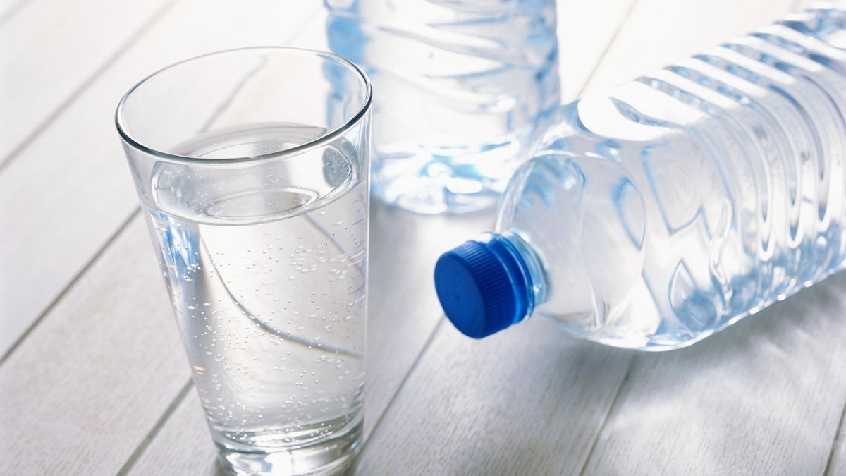 Glass of water with plastic water bottles on woodHitoshi Nishimura
