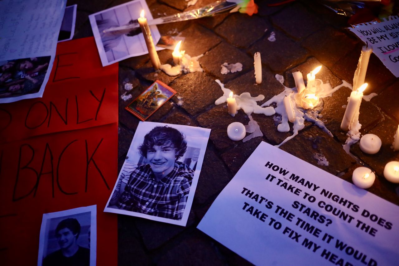 BUENOS AIRES, ARGENTINA - OCTOBER 17: A portrait of Liam Payne is seen next to candles as fans gather at the Obelisk on October 17, 2024 in Buenos Aires, Argentina. According to the Buenos Aires police department, Payne fell from a third-floor hotel room balcony in Palermo, a famous neighborhood in Buenos Aires. Fans around the city gather to pay tribute to the former member of boy band One Direction. (Photo by Marcos Brindicci/Getty Images)