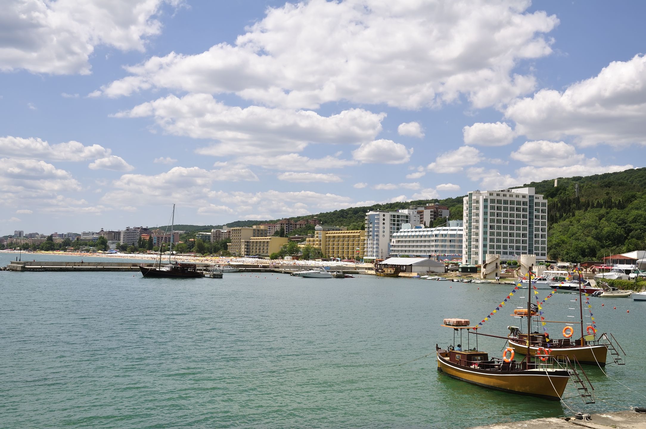 Panoramic of Golden Sands resort near Varna, BulgariaGolden Sands resort, at Black Sea, near Varna, Bulgaria. Beautiful cloudscape.MarholevVarna, Beach Umbrella, Cloudscape, Landscaped, Seascape, Coastline, Parasol, Jetty, Scenics, Yacht, Blue, Travel Destinations, Vacations, Panoramic, Bulgaria, Eastern Europe, Sunlight, Summer, Sand, Beach, Cloud - Sky, Sun, Sky, Black Sea, Sea, Water's Edge, Surf, Water, Hotel, Pier, Tourist Resort, Nautical Vessel, Yacht, Golden Sands, Travel Locations, Beaches, Holidays, Travel Backgrounds, Bulgarian Culture, Varna Province