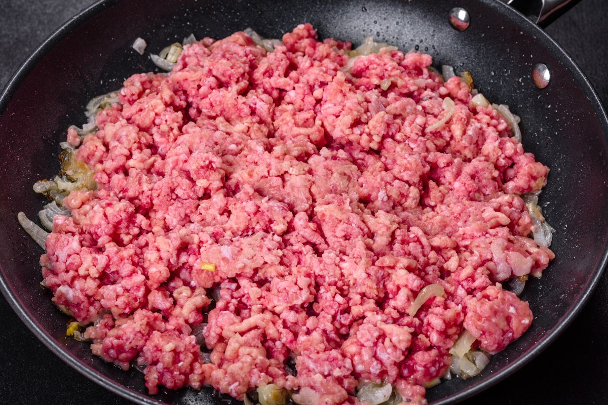 Ground meat releases water because during frying, protein degradation occurs.