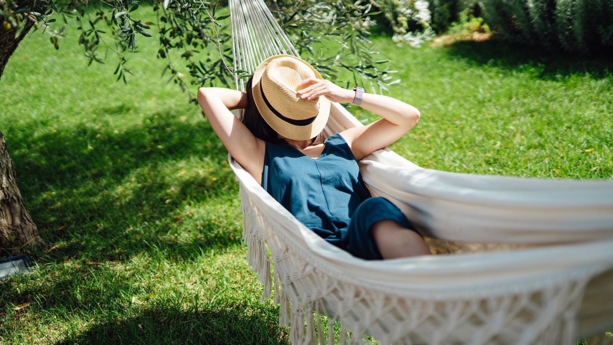 Young Asian woman covering her face with straw hat while taking an afternoon nap on hammock on a sunny day
Young Asian woman enjoying a relaxing holiday. Mindfulness and wellbeing concept.
Oscar Wong