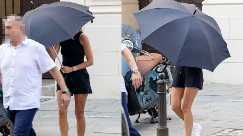 Izabela Janachowska zasłania się parasolem w drodze do samochodu