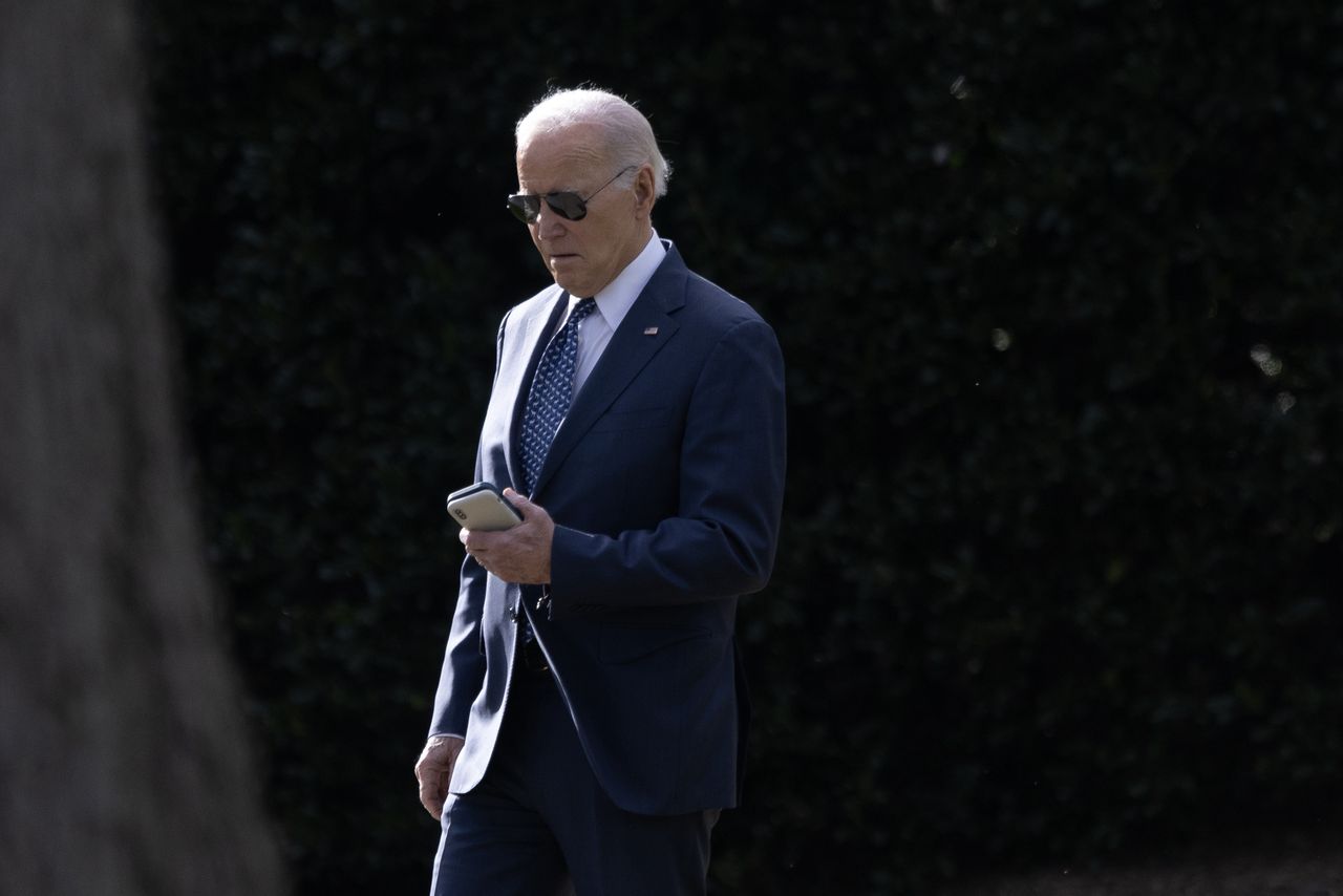 WASHINGTON - FEBRUARY 8: President Joe Biden checks a cell phone while walking to Marine One from the Oval Office at the White House, in Washington, D.C., on Thursday, February 8, 2024. Biden traveled to Leesburg, Virginia to deliver remarks at the House Democratic Caucus Issues Conference. (Photo by Tom Brenner for The Washington Post via Getty Images)