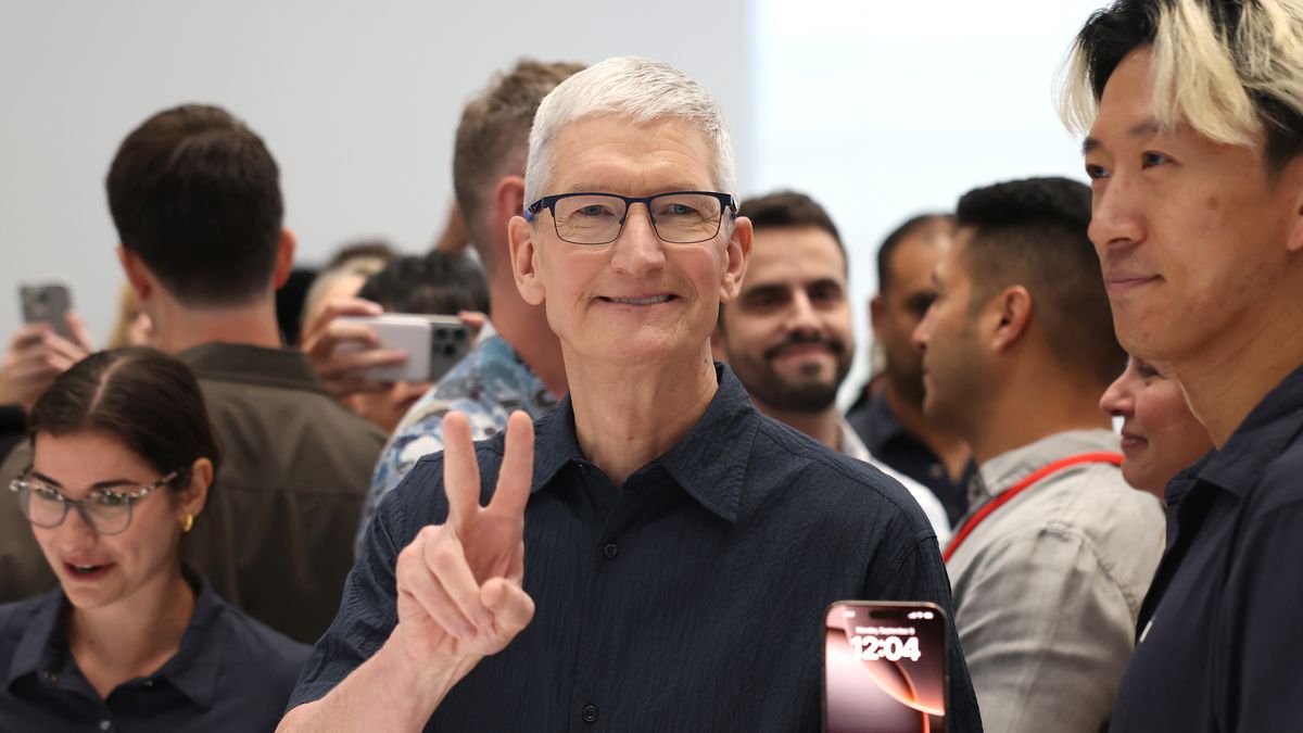 CUPERTINO, CALIFORNIA - SEPTEMBER 09: Apple CEO Tim Cook inspects the new iPhone 16 during an Apple special event at Apple headquarters on September 09, 2024 in Cupertino, California. Apple held an event to showcase the new iPhone 16, Airpods and Apple Watch models. (Photo by Justin Sullivan/Getty Images)
