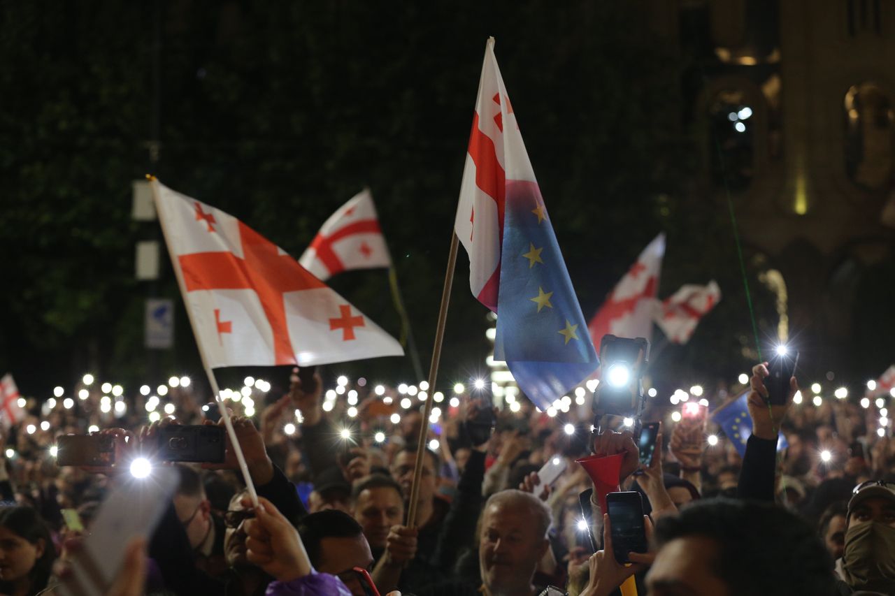 TBILISI, GEORGIA - MAY 15: People hold flags as they attend the ongoing protest against 'transparency of foreign influence' bill after government's approval in Tbilisi, Georgia on May 15, 2024. The Georgian Parliament has passed the bill concerning the 'Transparency of Foreign Influence,' proposed by the governing Georgian Dream Party. Concurrently, amidst the parliamentary proceedings, demonstrations opposing the legislation persisted in the vicinity of the legislative premises. (Photo by Davit Kachkachishvili/Anadolu via Getty Images)