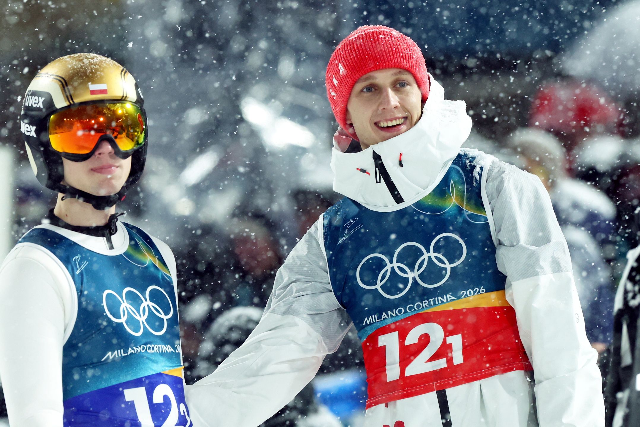 Predazzo, Włochy, 16.02.2026. Zimowe Igrzyska Olimpijskie - Mediolan i Cortina d?Ampezzo 2026. Polacy Kacper Tomasiak (L) i Paweł Wąsek (P) po swoich skokach w trzeciej serii konkursu super team w skokach narciarskich, 16 bm. w Predazzo. (js) PAP/Grzegorz Momot