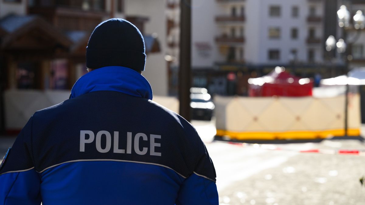 CRANS-MONTANA, SWITZERLAND - JANUARY 01: A policeman looks on where a fire broke out overnight at Le Constellation bar on January 01, 2026 in Crans-Montana, Switzerland. According to authorities, the fire began around 1:30 AM local time. (Photo by Harold Cunningham/Getty Images)