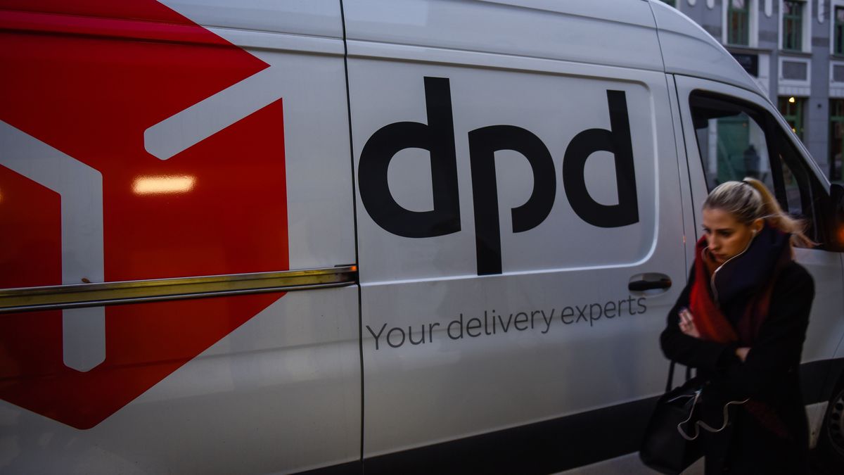 KRAKOW, POLAND - 2019/12/04: A woman walks by a international parcel delivery service van DPD in Krakow. (Photo by Omar Marques/SOPA Images/LightRocket via Getty Images)