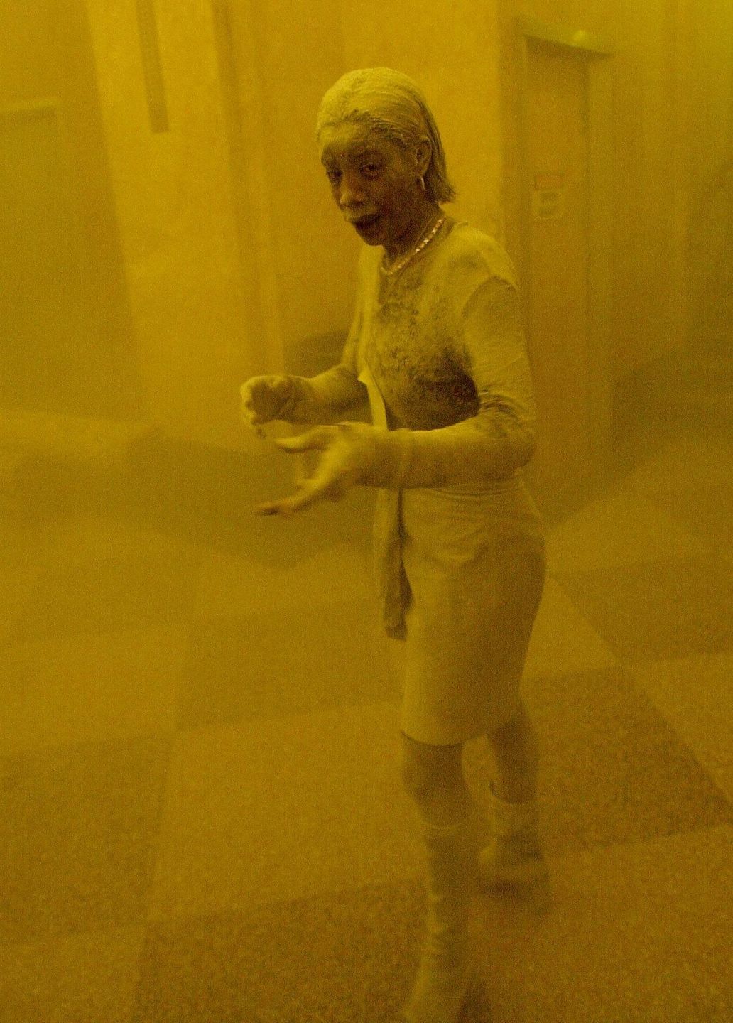 ALLFFM10 - 20020902 -NEW YORK, UNITED STATES : (FILES)  A woman is covered in dust as she takes refuge in a neighbouring office building after one of the World Trade Center towers collapsed following the attack by terrorists who hijacked two commercial planes 11 September 2001.  Last year's terrorist attacks on the World Trade Center and the Pentagon, killing about 3.000 people, lead to the massive strike on Osama bin-Laden's terrorist network al-Qaida in Afghanistan and all over the world.   (ORIGINALLY ISSUED AS JFK04) EPA PHOTO     AFPI  FILES / STAN HONDASTAN HONDAMarcy Borders