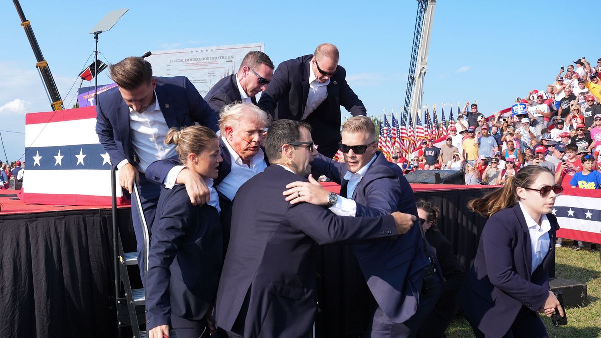 BUTLER, PENNSYLVANIA - July 13: Former president Donald Trump is assisted offstage during a campaign rally at Butler Farm Show Inc. on Saturday, July 13, 2024 in Butler, Pa. Trump ducked and was taken offstage after loud noises were heard after he began speaking. 
(Photo by Jabin Botsford/The Washington Post via Getty Images)