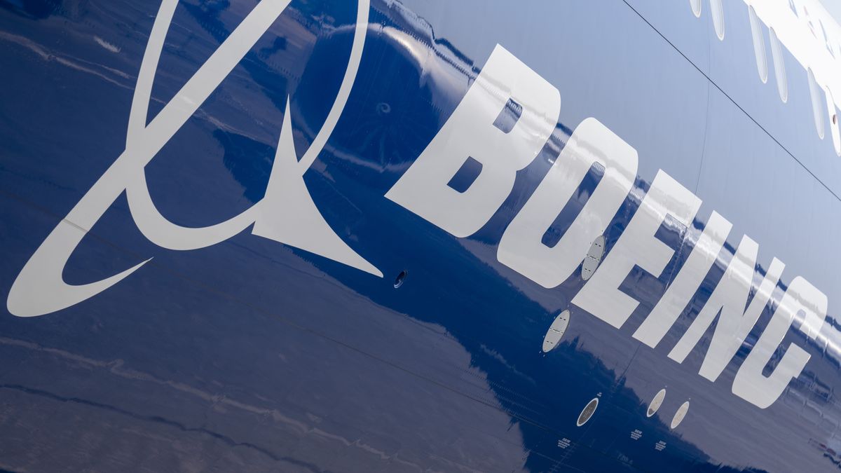 The Boeing logo on the fuselage of a 777X jet airliner at the Farnborough Airshow, on 18th July 2022, at Farnborough, England. The US aviation manufacturer is recovering from a financial downturn following the series of 737 Max crashes. The Farnborough International Airshow (FIA) is an aerospace and defence industry trade fair which, due to Covid, is being held for the first time in four years. The pandemic has had a major impact on commercial aviation, while the war in Ukraine has changed the mindset for defence industries. There are 1,200 exhibitors from 42 countries here with organisers hoping to attract more than 80,000 visitors over the week. (Photo by Richard Baker / In Pictures via Getty Images)