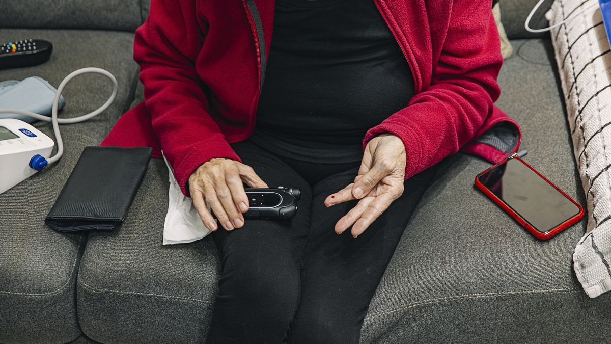 Senior woman taking blood sugar reading
Justin Paget