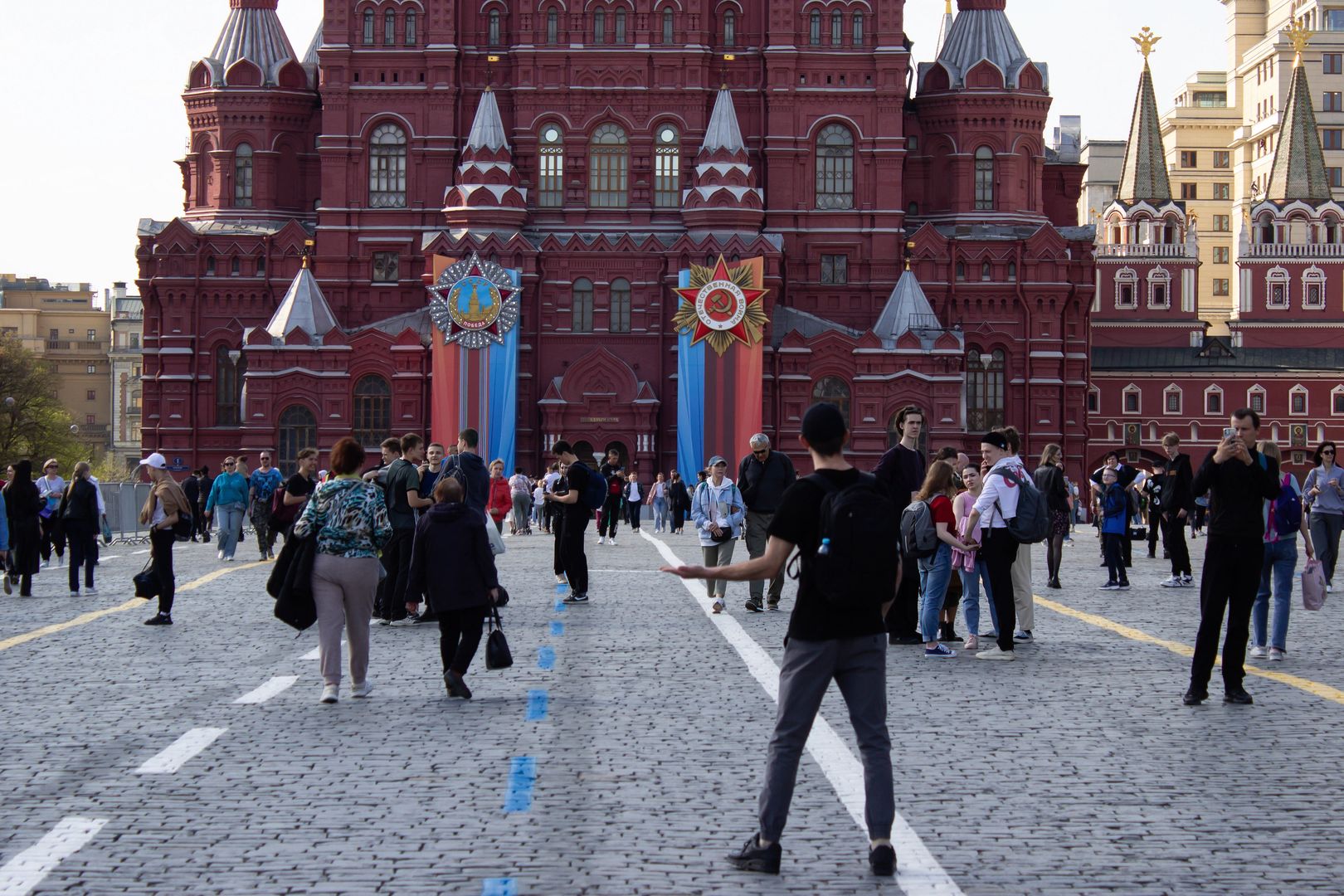 MOSCOW, RUSSIA - 2023/04/24: A tourist poses for a photo at Red Square with Victory Day decorations seen outside the State Museum in the Red Square. Russia celebrates Victory Day every year on May 9. Mass media reports that in 2023, only one foreign head of state will attend the traditional military parade on Red Square. (Photo by Vlad Karkov/SOPA Images/LightRocket via Getty Images)