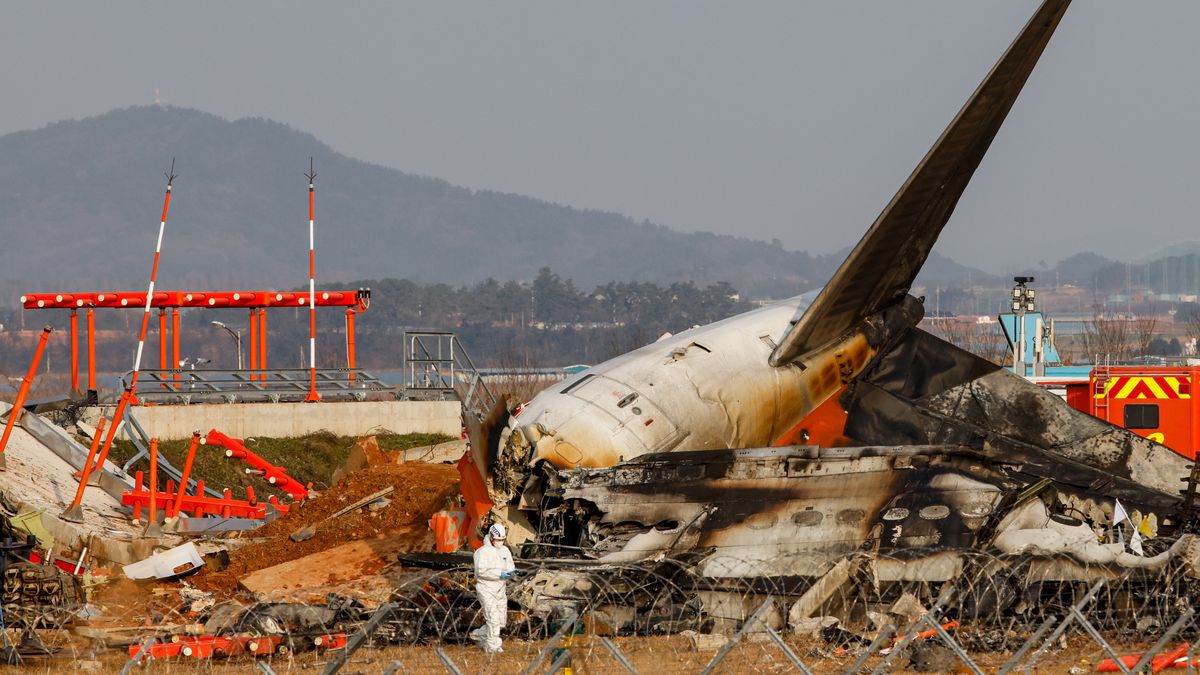 The localizer antenna facility, essential for guiding aircraft landings near the runway at Muan International Airport in Muan-gun, South Jeolla Province, South Korea, is damaged after a collision with Jeju Air Flight 7C2216 on December 29, 2024. Multiple international aviation experts point out that, unlike the standard design, where such facilities are placed at runway level or elevated on steel towers, the facility at Muan International Airport is secured with thick concrete on a 2-3 meter-high mound of soil. This unconventional design is highlighted as a potential key factor contributing to the tragedy. Jeju Air Flight 7C2216, a Boeing 737-800 carrying 181 people, skids off the runway and collides with a wall, triggering a devastating explosion. Only two crew members seated near the rear emergency exit survive. With 179 confirmed fatalities, this tragedy becomes the deadliest domestic passenger plane crash in South Korean history. Muan International Airport is located approximately 300 km southwest of central Seoul. (Photo by Chris Jung/NurPhoto via Getty Images)