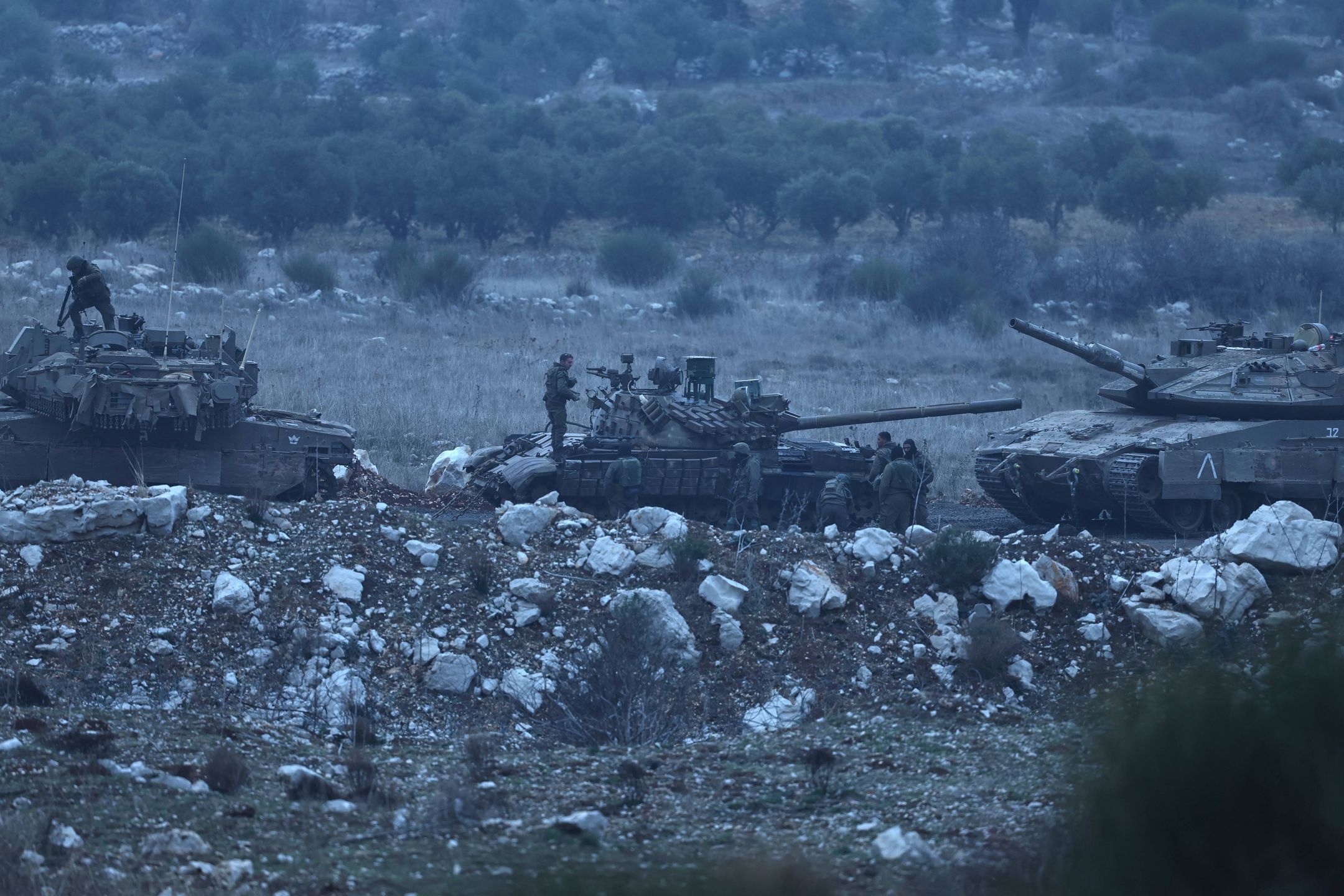 Israel boosts troop presence on Golan Heights amid developments in Syria
epa11788669 Israeli soldiers stand near a Syrian T-72 tank inside the buffer zone prior to transfer it into Israel, on the border between Israel and Syria, near the Druze village of Majdal Shams, in the Israeli-annexed Golan Heights, 21 December 2024. Israel's military said that its troops are conducting 'defense activities' along the border with Syria in the Golan Heights, northern Golan Heights, and Mount Hermon, to prevent 'any threat' from 'terrorist elements' in the area.  EPA/ATEF SAFADI 
Dostawca: PAP/EPA.
ATEF SAFADI
Israeli, military, tank, buffer zone, Syria border