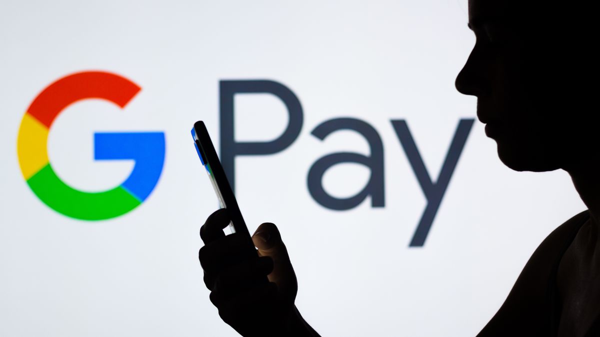 BRAZIL - 2022/04/21: In this photo illustration the Google Pay logo seen in the background of a silhouetted woman holding a mobile phone. (Photo Illustration by Rafael Henrique/SOPA Images/LightRocket via Getty Images)