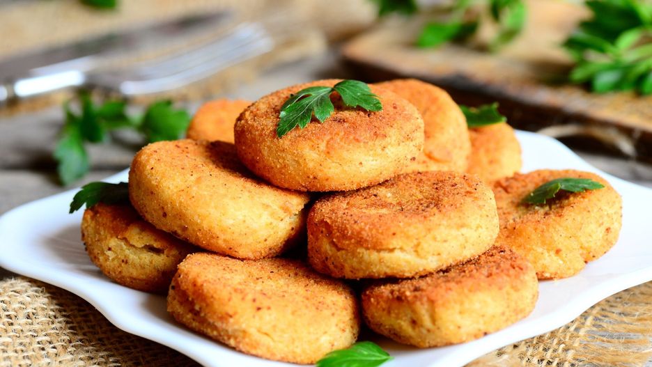 Fried veggie burgers on a plate. Delicious chickpea burgers decorated with parsley. Rustic style. Closeup
