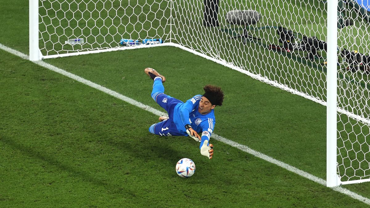 DOHA, QATAR - NOVEMBER 22: Mexico goalkeeper Guillermo Ochoa saves a penalty kick from Robert Lewandowski of Poland during the FIFA World Cup Qatar 2022 Group C match between Mexico and Poland at Stadium 974 on November 22, 2022 in Doha, Qatar. (Photo by Charlotte Wilson/Offside/Offside via Getty Images)