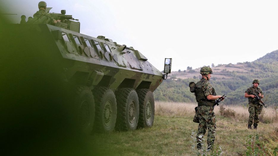 arch47
Serbian army soldiers stand guard by their armoured vehicle in the village of Rudnica near the southern Serbian town of Raska on September 27, 2021, where tensions are high at the border between Kosovo and Serbia as Belgrade deployed four armoured vehicles close to the frontier, an AFP correspondent saw. - Already tense relations between Serbia and its former ethnic-Albanian majority province have grown worse since the government in Kosovo despatched special police units to the north a week ago, an area mainly populated by ethnic Serbs who reject the authority of Pristina. The move, which angered the Serbs, came after Pristina decided to require drivers with Serbian registration plates to put on temporary ones when entering Kosovo. (Photo by Irfan LICINA / AFP)
IRFAN LICINA