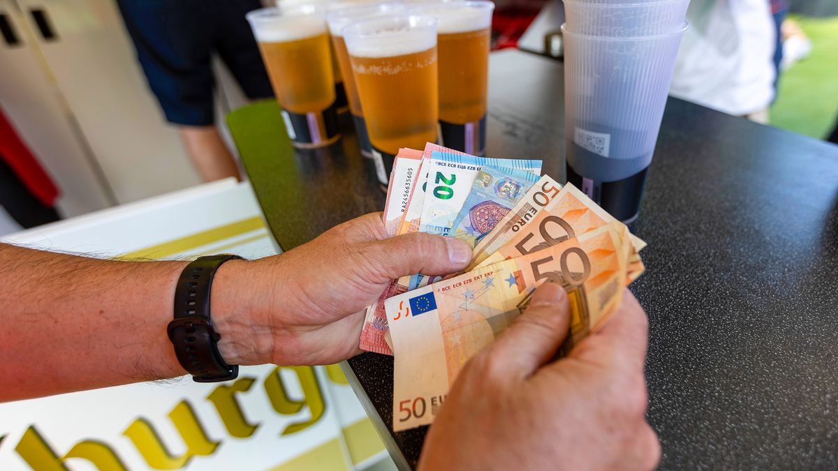 A customer counts euro banknotes at a drinks vendor in the Fan Zone public viewing area at the Brandenburg Gate before the Netherlands-Austria Euro 2024 Soccer Championship match in Berlin, Germany, on Tuesday, June 25, 2024. The economic pickup in 2024 marks the euro area's best chance yet to draw a line on years of disruption, ranging from the pandemic to the cost-of-living crisis that then followed. Photographer: Krisztian Bocsi/Bloomberg via Getty Images